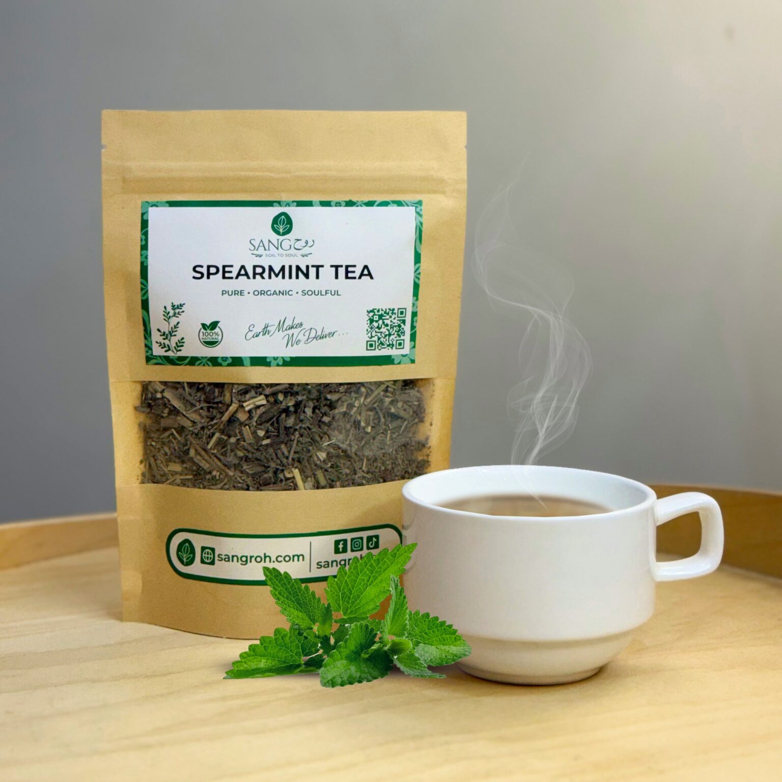 Pure organic spearmint tea leaves in resealable pouch with freshly brewed spearmint tea for digestion and refreshing calm